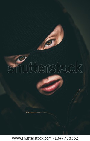 Man in a mask on black background.