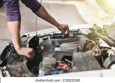 Man master repairs under the hood of the car. Repairing concept - Shutterstock ID 1720232185