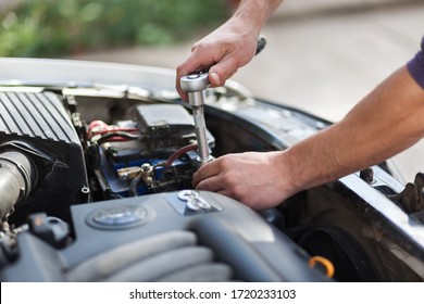 Man master repairs under the hood of the car. Repairing concept