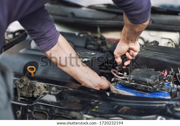 Man master repairs under the hood of the car.
Repairing concept