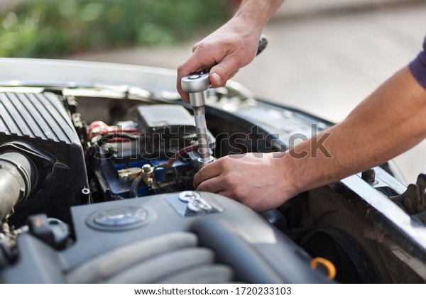Man master repairs under the hood of the car.\
Repairing concept