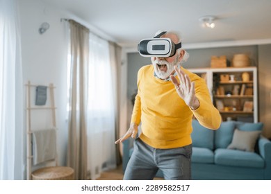 man mature senior caucasian male at home enjoy virtual reality VR headset - Powered by Shutterstock