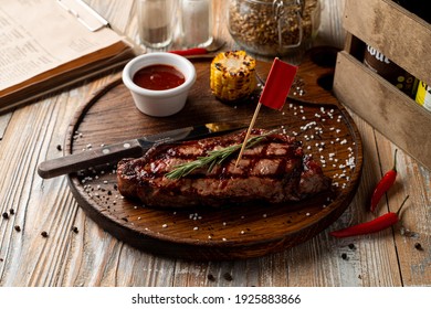 Man Meal: A Loin Steak With Grill Traces On It With With Roasted Corn Side, Pub Atmosphere