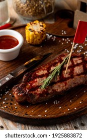 Man Meal: A Loin Steak With Grill Traces On It With With Roasted Corn Side, Pub Atmosphere