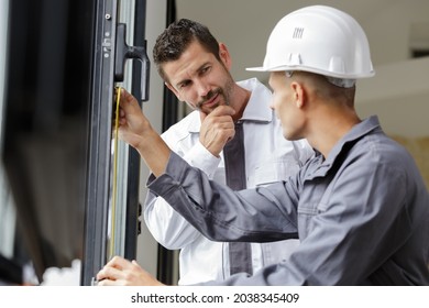 A Man Measuring Double Glazing Door