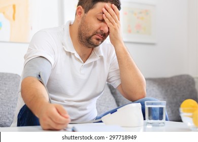 Man Measuring  His Blood Pressure Feeling Sick.