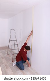 Man Measuring Wall