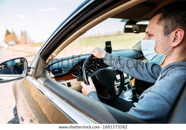 Man in the medical mask in car.\
coronavirus, disease, infection, quarantine,\
covid-19