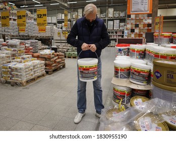  Man In A Medical Mask Selects Paint In The OBI Store. Poland, Opole, 08.10. Selective Focus 