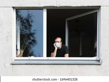 Man in medical protective face mask looking through window.Coronavirus pandemic covid-19.Man in corona quarantine looking out of window to the street.Man with face mask at home.During covid-19 quarant - Powered by Shutterstock