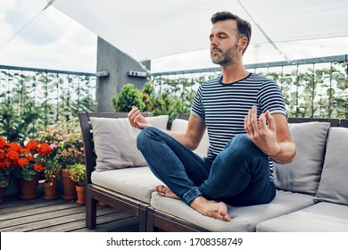 man meditating on terrace during sunny day - Powered by Shutterstock