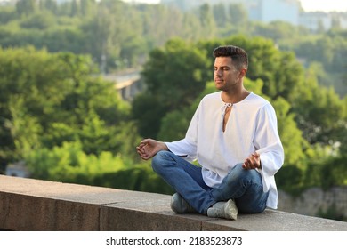 Man Meditating Outdoors On Summer Day. Space For Text