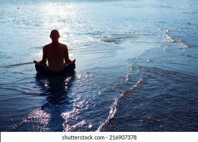 Man meditating upon the ocean