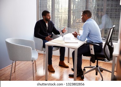 Man Meeting With Male Financial Advisor Relationship Counsellor In Office