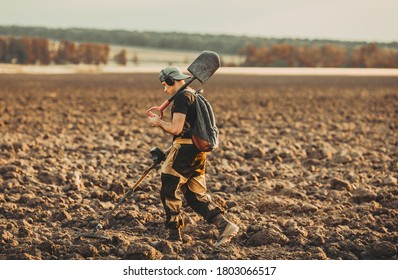 Man With A Metal Detector In The Field. Search For Treasures.