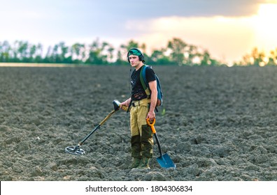 Man With A Metal Detector In The Field. Search For Treasures.