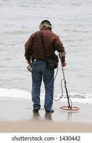 Man With A Metal Detector Searching For The Mother Lode