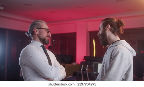 Man In Middle Aged Suit Employer Is Working On A Joint Project With His Young Employee