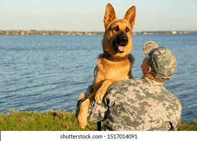 Man In Military Uniform With German Shepherd Dog Outdoors