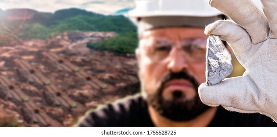 Man Miner Holding Silver Stone, In The Background A Large Open Pit Mining Company In The City Of Mexico, Zacatecas.