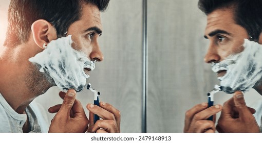 Man, mirror and foam for shaving in bathroom, skincare and hair removal for cleaning in home. Male person, reflection and soap or cream for grooming beard, cosmetics and blade for facial treatment - Powered by Shutterstock