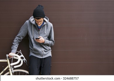 Man With Mobile Phone And Bicycle