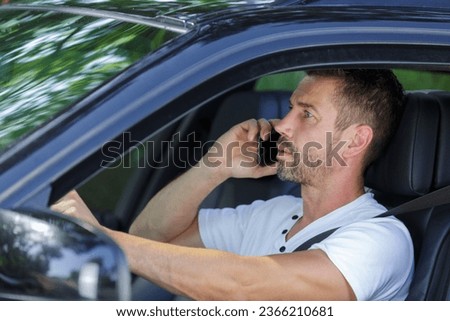 man with mobile telephone to his ear while driving Imagine de stoc © 