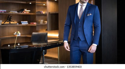 Man Model In Expensive Custom Tailored Suit Standing In His Office And Posing