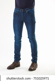 Man Model Posing In Dark Blue Jeans  And Brown Shoes In Light Studio 