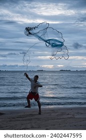 a man model throwing fishing net in the air.
