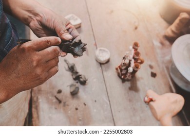 Man molding clay to make ceramics with his hands, Artisan working in his workshop, Selective Focus - Shutterstock ID 2255002803