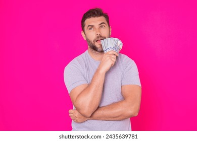 Man with money cash. Dollar banknotes. Portrait of man holding bunch of money banknotes. Dollar bills, credit, online banking. Rich man pointing at dollar banknotes, bank loan, financial savings.