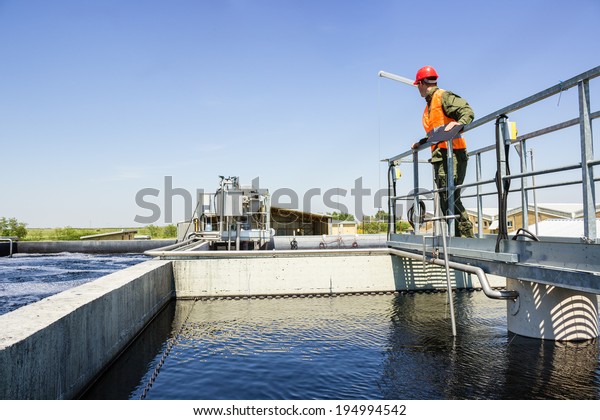 Man monitor
filtering water in factory.
