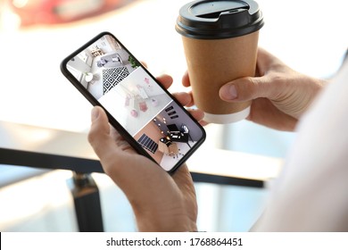 Man monitoring modern CCTV cameras on smartphone indoors, closeup. Home security system - Shutterstock ID 1768864451