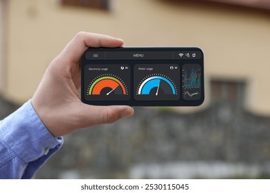 Man monitoring smart meter readings on mobile phone outdoors, closeup