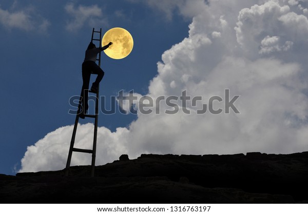 Man and moon in blue\
sky