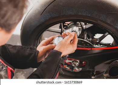 man motorcycle tire manual air pressure testing before traveling trip for safety riding vehicle - Shutterstock ID 1615730869