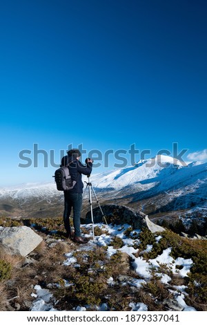 Similar – Hiker photographs the landscape