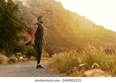 Man, mountain and stretching with headphones in fitness for training, exercise or workout music. Male person, runner and thinking in nature with preparation for balance, sports or podcast for warm up - Powered by Shutterstock