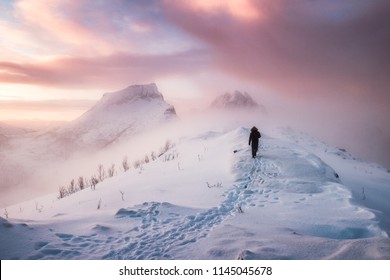 Man Mountaineer Walking With Snow Footprint On Snow Peak Ridge In Blizzard At Morning