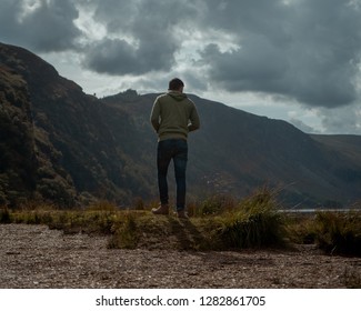 Man with mountains in the background.