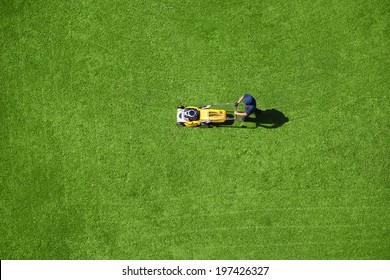 A Man Mowing The Lawn