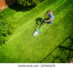 A Man Mowing The Lawn - Aerial Photo