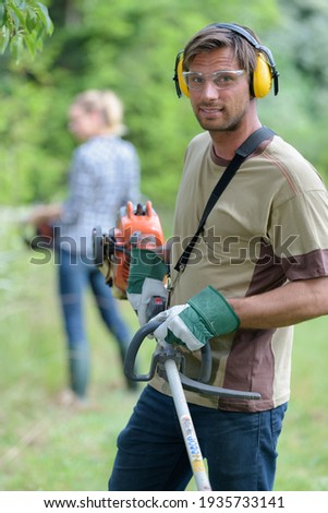 a man mows the grass