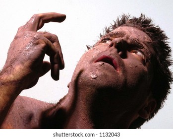 man with mud clay face