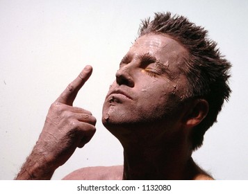 man with mud clay face