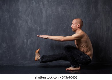 A Man With A Naked Torso Doing Pistol Squats On One Leg