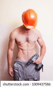A man with a naked torso holding a screwdriver