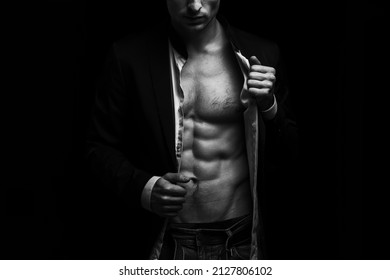 Man with a naked torso on a black background