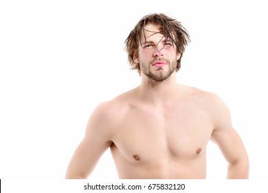 Man with naked torso, passionate face, beard and messy hair. Idea of strength and sportive shape. Gym and healthy lifestyle concept. Guy with muscles and strong body isolated on white background